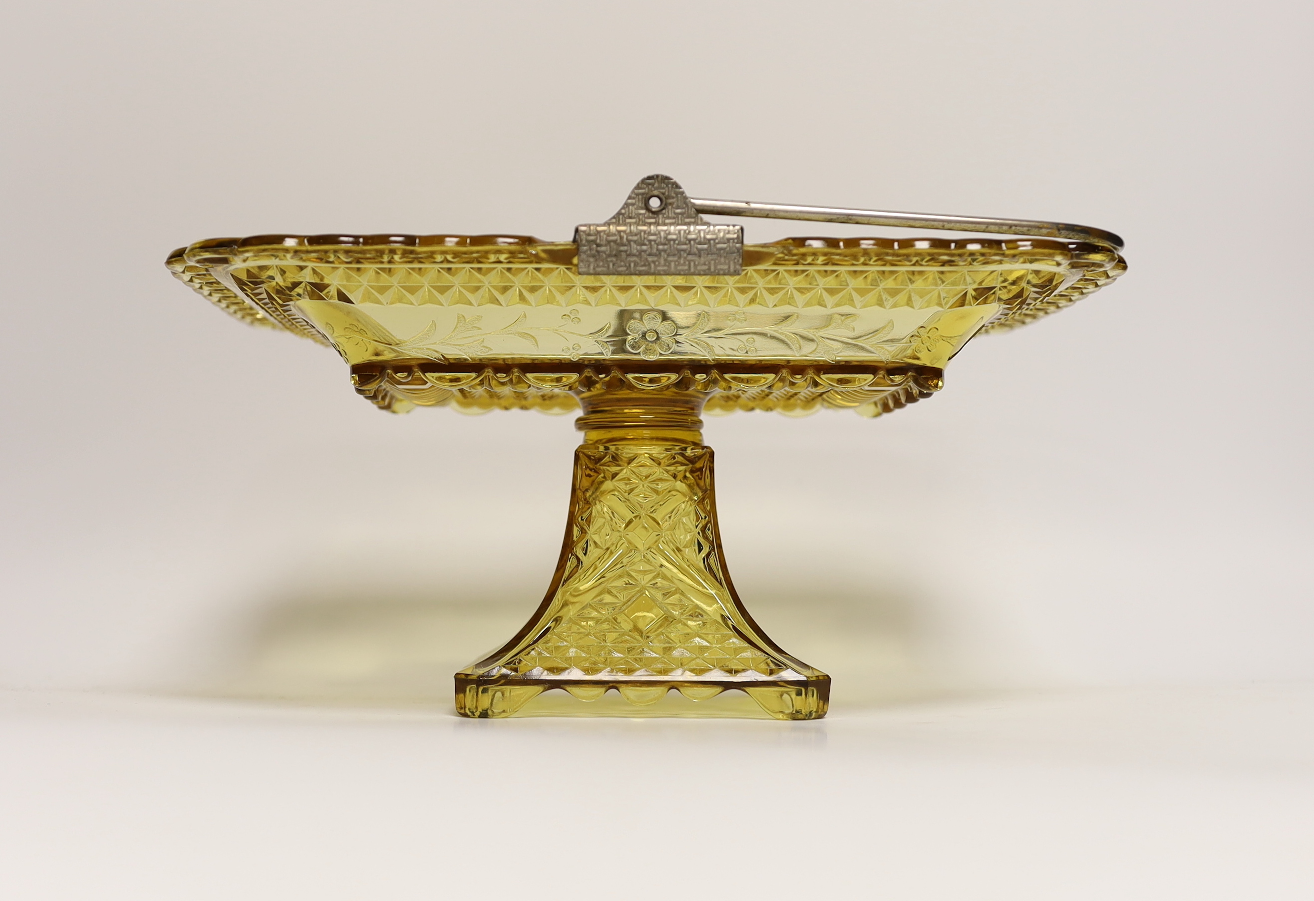 An American amber pressed glass comport/basket with swing handle, probably Pittsburg, 27cm wide